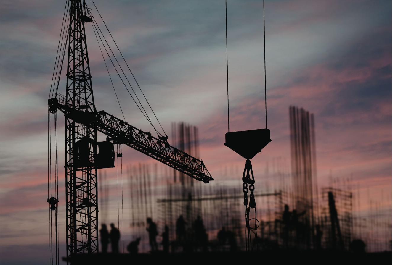Construction crane silhouette at sunset