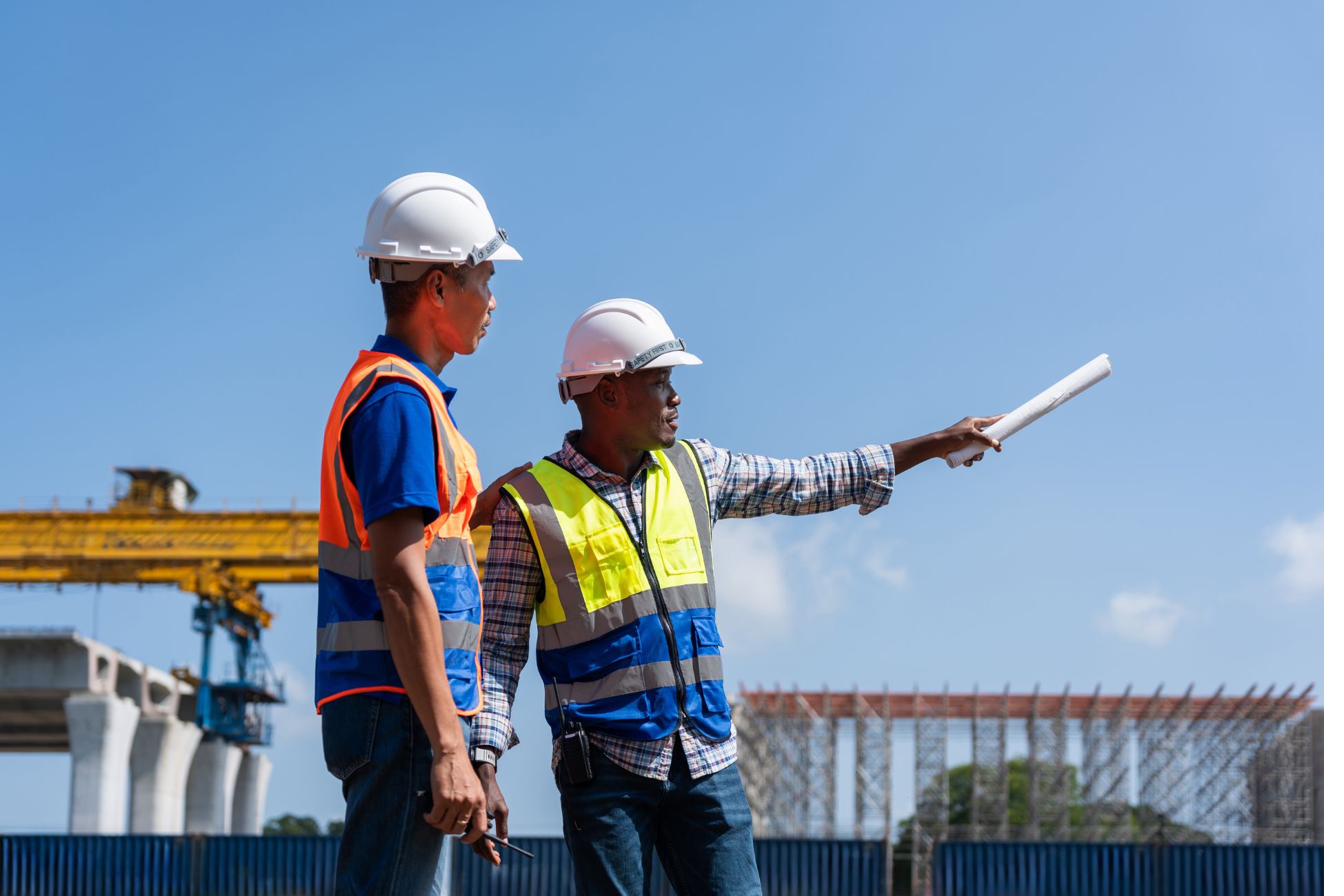 Construction professionals on jobsite reviewing plans